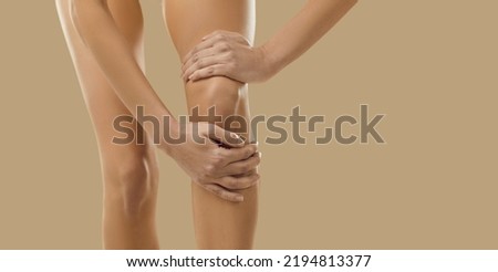 Narrow show crop closeup image of woman on yellow background suffer from knee ache. Acute pain in kneecap. Unhealthy female touch leg having arthritis or osteoporosis. Healthcare problem. Stock foto © 