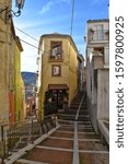 A narrow street between the old houses of an Italian town in the Molise region