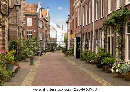 Narrow street with flower boxes in the center of the Dutch city of Haarlem.