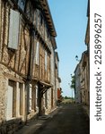 A narrow street line with picturesque old homes in Beauville, Lot-et-Garonne, France