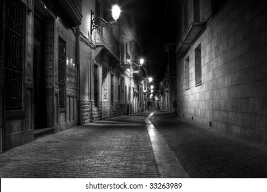 A Narrow Street at Night in Europe - Powered by Shutterstock