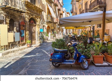 Narrow street in the old town of Cefalu in Sicily, Italy in a beautiful summer day