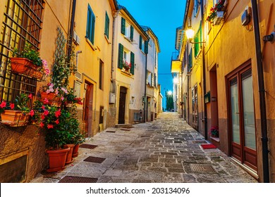 Narrow street in the old town at night in Italy - Powered by Shutterstock