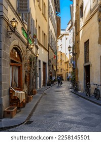 Narrow street with old trattoria in Florence, Tuscany, Italy. Architecture and landmark of Florence. Cozy Florence cityscape