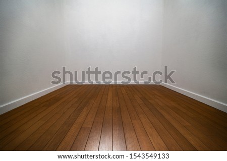 Narrow white room. Three walls of a white room with wood flooring and white trims.