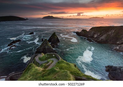 A narrow winding path leads down the cliffs at Dunquin on the Dingle Peninsula, in Ireland's County Kerry, with the Blasket Islands beyind. - Shutterstock ID 502271269