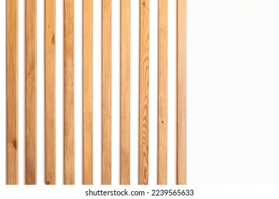 narrow wooden slats on a white plastered wall as an element of modern decor in a minimalistic interior design