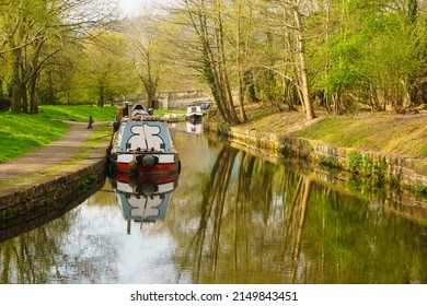 Narrowboats moored up on a tranquil leafy part of the Llangollen canal in the Trevor Basin at the Froncysyllte aqueduct on the inland waterway network in North Wales UK