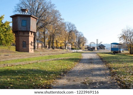 Narrow-gauge railway station in Anyksciai with few trains and train cars waiting for morning passengers in Lithuania