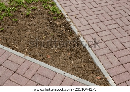 Narrowing the pavement - empty space between it for growing plants