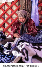 Naryn, Kyrgyzstan - 10 July 2008 : Unidentified Kyrgyz Stitching  A Wool Carpet Used To Build Yurt, A Traditional Nomadic House. 