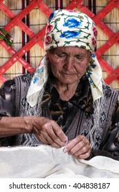 Naryn, Kyrgyzstan - 10 July 2008 : Unidentified Kyrgyz Stitching  A Wool Carpet Used To Build Yurt, A Traditional Nomadic House. 