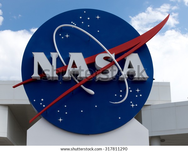 NASA sign at Cape Canaveral, Kennedy Space Center with blue cloudy sky background. Elements of this image furnished by NASA.