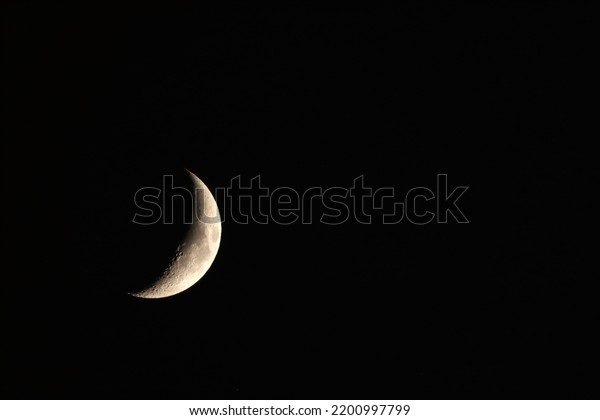 The nascent moon in the black sky. Good quality.\
Craters are clearly visible