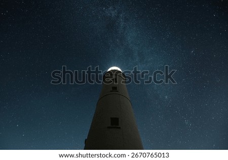 Nash Point lighthouse under starry sky