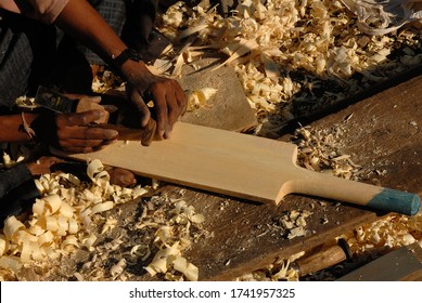 Nashik, Maharashtra, India, Asia, Dec. 09, 2006 - Poor Indian Man Carpanter Making A Generic Wooden Cricket Bat In Work Shop