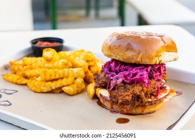 A Nashville hot chicken sandwich with purple slaw and fries