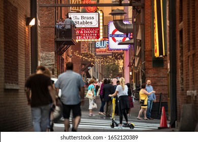 Nashville, Tennessee - June 20, 2019:  People Ride Scooters And Walk Down Printer's Alley During The Day In Downtown Nashville Tennessee USA.  Now It Is The Center Of Nashville's Nightlife.