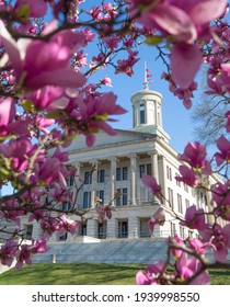 Nashville, Tennessee - March 20, 2021: Tennessee State Capitol Building On A Bright, Sunny First Day Of Spring With Magnolia Flowers