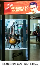 Nashville, Tennessee - March 22, 2019 : 'Welcome To Nashville' Sign Behind A Guitar Case At Nashville International Airport (BNA)