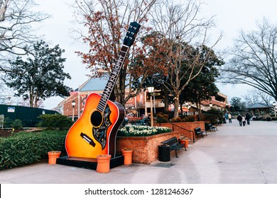 NASHVILLE, TN, USA - February 27, 2018: The Grand Ole Opry Is One Of The Most Famous Music Venues Since Being Created In 1925. The Area Around It Is Filled With Guitars, A Food Truck And Seating.