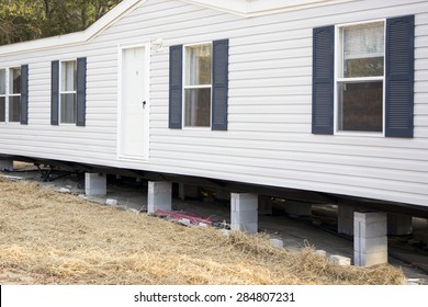 NASHVILLE, TN-MAY, 2015:  New mobile home is being installed on its cement block foundation.  