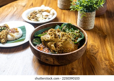 Nasi Ayam Betutu is Balinese cuisine made of steamed chicken with rice and vegetables. - Shutterstock ID 2250390103