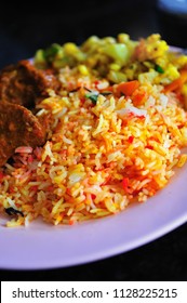 Nasi Biriyani Is A Fusion Of Indian And Malay Cuisines.(Nasi Means Rice). Spiced Rice Accompanied With Delicious Curry Chicken. It Found Also In Singapore.