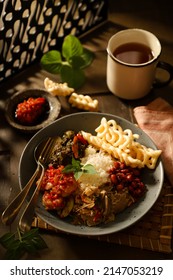 Nasi Campur. Indonesian Meal Of Rice With Side Dishes Of Beef Stew In Green Chili Paste, Shrimp In Red Chili Paste, Stirfried Banana Blossom, Peanut Anchovy And Tapioca Crackers.