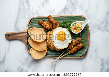 Nasi goreng with prawn crackers and chicken satay , indonesian dish,Chicken Satay Fried Rice