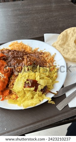 Nasi kandar with dishes of ayam goreng, vegies, papadom, and mixed gravies.