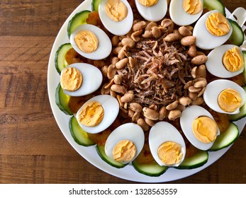 Nasi Lemak Cake With Condiments Of Hard Boiled Eggs, Peanuts, Fried Anchovies, Cucumber Slices And Chili Shrimp