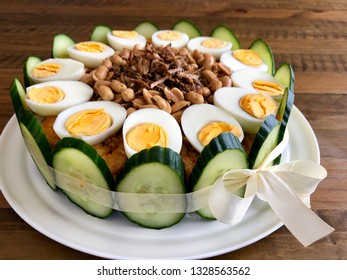 Nasi Lemak Cake With Condiments Of Hard Boiled Eggs, Peanuts, Fried Anchovies, Cucumber Slices And Chili Shrimp