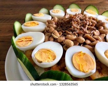 Nasi Lemak Cake With Condiments Of Hard Boiled Eggs, Peanuts, Fried Anchovies, Cucumber Slices And Chili Shrimp