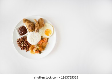 Nasi Lemak Flatlay On White Table. Singapore Food, Malaysian Food Called Nasi Lemak Or Coconut Rice, Shot Top Down. Nasi Lemak With Copy Space. 