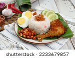 Nasi lemak -Malay fragrant rice dish cooked in coconut milk and pandan leaf.served with various side dishes