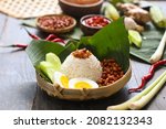 nasi lemak, a traditional malay curry paste rice dish served on a banana leaf