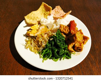 Nasi Tumpang Is The Vegetables With Traditional Cooking Spices Plus Egg And Rice