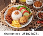 Nasi uduk is a dish made from diaroned white rice steamed with coconut milk, and seasoned with nutmeg, cinnamon, ginger, lemongrass leaves and pepper, which is popular in Betawi dishes