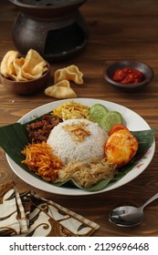 Nasi uduk is a typical Indonesian food made from rice cooked with coconut milk, served with eggs, tempeh and potatoes,selective focus - Shutterstock ID 2129696468