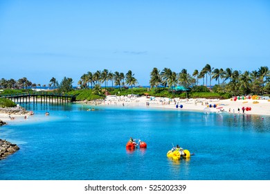 Nassau, Bahamas- March 09, 2016: Summer Beach With Catamarans In Water And People On Vacation With Blue Sky And Green Palms On Sunny Coast On Natural Background