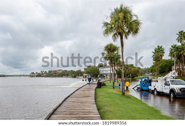 Nassau Bay, TX, US - September\
22, 2020: Nassau Bay flood control crew pumps storm surge water\
from Tropical Storm Beta back into Clear Lake in Nassau Bay\
Texas.
