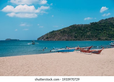 Nasugbu, Batangas, Philippines - March 2021: Calayo Beach At Midday. Multiple Fishing Boats Hauled Onto The Sand.