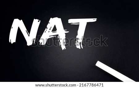 NAT Text on a Black Chalkboard with a piece of chalk
