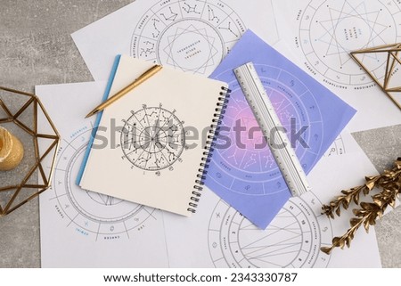 Natal charts for making forecast of fate and astrological items for fortune telling on table, flat lay