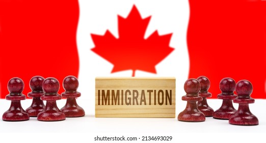 national concept. Against the background of the flag of Canada, pawns and a sign with the inscription - immigration