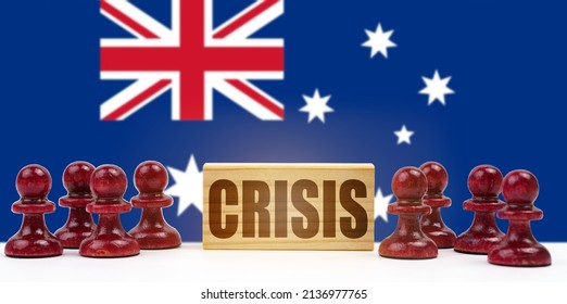 National Concept. Against The Background Of The Flag Of Australia, Pawns And A Sign With The Inscription - Crisis