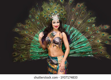 National dancer in a luxurious outfit of bird feathers on a black background, isolated.