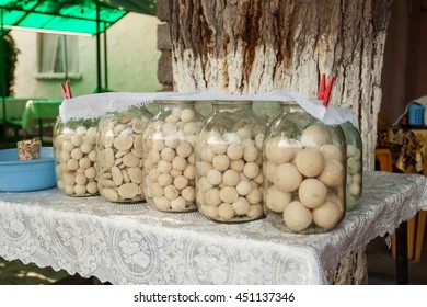 The National Dish Of Uzbekistan - Kurt. 5 A Three-liter Cans With Kurt Standing On The Table, The Banks Covered With Gauze.   Dry Milk Product. Represents The White Balls The Size Of An Apricot. 