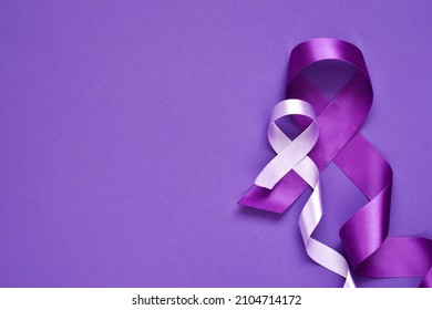 National Epilepsy or Alzheimer disease Day Concept. Purple ribbons symbol of Pancreatic cancer awareness and world Lupus Day and world cancer on purple background. copy space, flat lay